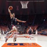 Arizona guard Pelle Larsson goes up for a dunk during the first half of an NCAA college basketball game against Illinois Saturday, Dec. 11, 2021, in Champaign, Ill. (AP Photo/Charles Rex Arbogast)