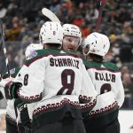 Arizona Coyotes right wing Christian Fischer, center, celebrates with center Nick Schmaltz (8) and right wing Clayton Keller (9) after scoring a goal during the first period of an NHL hockey game against the Anaheim Ducks in Anaheim, Calif., Friday, Dec. 17, 2021. (AP Photo/Ashley Landis)