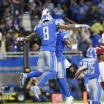Detroit Lions wide receiver Josh Reynolds (8) celebrates his 22-yard pass for a touchdown during the first half of an NFL football game against the Arizona Cardinals, Sunday, Dec. 19, 2021, in Detroit. (AP Photo/Jose Juarez)