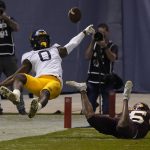 Minnesota defensive back Coney Durr breaks up a pass intended for West Virginia wide receiver Bryce Ford-Wheaton (0) during the second half of the Guaranteed Rate Bowl NCAA college football game Tuesday, Dec. 28, 2021, in Phoenix. Minnesota won 18-6. (AP Photo/Rick Scuteri)