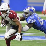 Arizona Cardinals wide receiver Rondale Moore (4) is stopped by Detroit Lions outside linebacker Charles Harris (53) during the first half of an NFL football game, Sunday, Dec. 19, 2021, in Detroit. (AP Photo/Lon Horwedel)