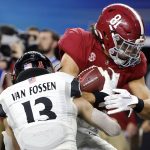 Alabama tight end Cameron Latu (81) scores a touchdown after catching a pass as Cincinnati linebacker Ty Van Fossen (13) defends during the second half of the Cotton Bowl NCAA College Football Playoff semifinal game, Friday, Dec. 31, 2021, in Arlington, Texas. (AP Photo/Michael Ainsworth)