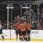 The Anaheim Ducks celebrate after defenseman Hampus Lindholm (47) scored a goal during the first period of an NHL hockey game against the Arizona Coyotes in Anaheim, Calif., Friday, Dec. 17, 2021. (AP Photo/Ashley Landis)