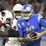Detroit Lions quarterback Jared Goff (16) is sacked by Arizona Cardinals defensive tackle Jordan Phillips (97) during the first half of an NFL football game, Sunday, Dec. 19, 2021, in Detroit. (AP Photo/Lon Horwedel)