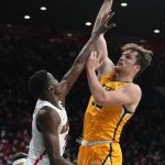 Northern Colorado center Theo Hughes, right, shoots over Arizona center Christian Koloko during the first half of an NCAA college basketball game, Wednesday, Dec. 15, 2021, in Tucson, Ariz. (AP Photo/Rick Scuteri)