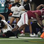 Alabama wide receiver Ja'Corey Brooks (7) scores a touchdown after catching a pass as Cincinnati safety Bryan Cook (6) defends during the first half of the Cotton Bowl NCAA College Football Playoff semifinal game, Friday, Dec. 31, 2021, in Arlington, Texas. (AP Photo/Jeffrey McWhorter)