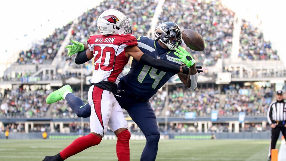 DK Metcalf #14 of the Seattle Seahawks attempts to make a catch in front of Marco Wilson #20 of the...