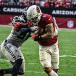Cardinals RB James Conner breaks a tackle on the way to his first TD against Seattle 1/09/22 (Jeremy Schnell/Arizona Sports)
