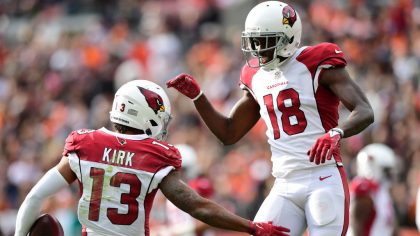 Christian Kirk #13 celebrates his touchdown with teammate A.J. Green #18 during the first quarter a...