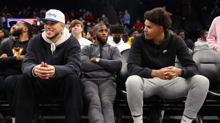 NBA athletes, (L-R) Devin Booker, Chris Paul and Cameron Johnson of the Phoenix Suns attend the Hoo...