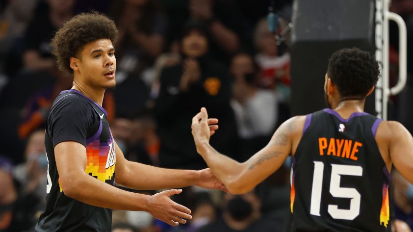 Cameron Johnson #23 of the Phoenix Suns reacts with Cameron Payne #15 after a three-point shot agai...