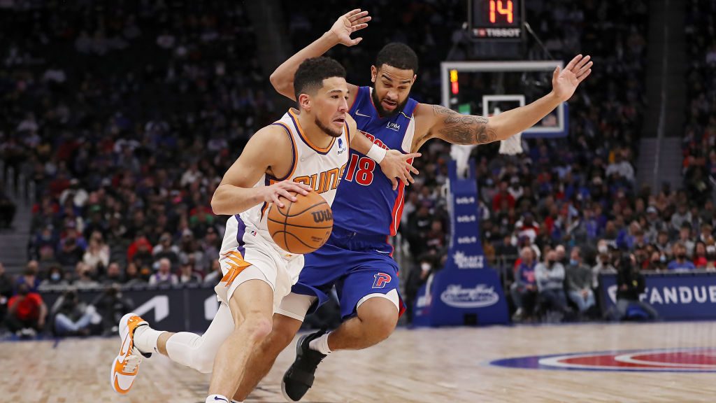 Devin Booker #1 of the Phoenix Suns drives against Cory Joseph #18 of the Detroit Pistons in the se...