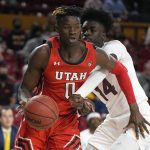 Utah center Lahat Thioune drives against Arizona State center Enoch Boakye (14) during the first half of an NCAA college basketball game, Monday, Jan. 17, 2022, in Tempe, Ariz. (AP Photo/Rick Scuteri)