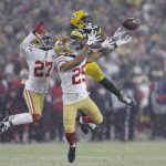 San Francisco 49ers' Talanoa Hufanga and Dontae Johnson break up a pass intended for Green Bay Packers' Davante Adams during the second half of an NFC divisional playoff NFL football game Saturday, Jan. 22, 2022, in Green Bay, Wis. The 49ers won 13-10 to advance to the NFC Chasmpionship game. (AP Photo/Matt Ludtke)