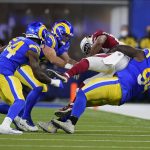 Los Angeles Rams defensive end A'Shawn Robinson (94) tackles Arizona Cardinals tight end Darrell Daniels during the second half of an NFL wild-card playoff football game in Inglewood, Calif., Monday, Jan. 17, 2022. (AP Photo/Marcio Jose Sanchez)
