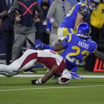 Arizona Cardinals safety Budda Baker, bottom, falls forward after tackling Los Angeles Rams running back Cam Akers (23) during the second half of an NFL wild-card playoff football game in Inglewood, Calif., Monday, Jan. 17, 2022. (AP Photo/Mark J. Terrill)