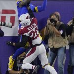 Los Angeles Rams wide receiver Odell Beckham Jr., top, catches a touchdown against Arizona Cardinals cornerback Marco Wilson (20) during the first half of an NFL wild-card playoff football game in Inglewood, Calif., Monday, Jan. 17, 2022. (AP Photo/Mark J. Terrill)
