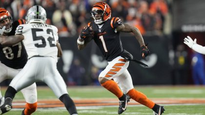 Cincinnati Bengals' Ja'Marr Chase (1) runs during the second half of an NFL wild-card playoff footb...