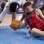 UCLA guard Jaime Jaquez Jr., left, and Arizona guard Pelle Larsson battle for a loose ball during the first half of an NCAA college basketball game Tuesday, Jan. 25, 2022, in Los Angeles. (AP Photo/Mark J. Terrill)
