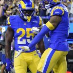 Los Angeles Rams wide receiver Odell Beckham Jr., right, is congratulated by running back Sony Michel (25) after scoring a touchdown against the Arizona Cardinals during the first half of an NFL wild-card playoff football game in Inglewood, Calif., Monday, Jan. 17, 2022. (AP Photo/Marcio Jose Sanchez)