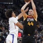 Utah Jazz forward Bojan Bogdanovic (44) shoots over Phoenix Suns forward Cameron Johnson during the first half during an NBA basketball game Wednesday, Jan. 26, 2022, in Salt Lake City. (AP Photo/Rick Bowmer)