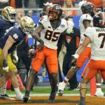 Oklahoma State wide receiver Jaden Bray (85) celebrates his touchdown against Notre Dame during the first half of the Fiesta Bowl NCAA college football game, Saturday, Jan. 1, 2022, in Glendale, Ariz. (AP Photo/Rick Scuteri)