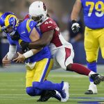 Los Angeles Rams quarterback Matthew Stafford, left, is sacked by Arizona Cardinals outside linebacker Markus Golden during the first half of an NFL wild-card playoff football game in Inglewood, Calif., Monday, Jan. 17, 2022. (AP Photo/Jae C. Hong)