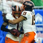 Oklahoma State wide receiver Tay Martin (1) celebrates his touchdown pass against Notre Dame with wide receiver Bryson Green (19) during the first half of the Fiesta Bowl NCAA college football game, Saturday, Jan. 1, 2022, in Glendale, Ariz. (AP Photo/Ross D. Franklin)