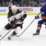 Arizona Coyotes right wing Christian Fischer (36) skates around New York Islanders defenseman Zdeno Chara (33) during the first period of an NHL hockey game, Friday, Jan. 21, 2022, in Elmont, N.Y. (AP Photo/Corey Sipkin).
