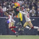 Green Bay Packers' Davante Adams can't catch a pass between San Francisco 49ers' Dontae Johnson and Talanoa Hufanga during the second half of an NFC divisional playoff NFL football game Saturday, Jan. 22, 2022, in Green Bay, Wis. (AP Photo/Aaron Gash)