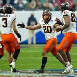 Oklahoma State linebacker Malcolm Rodriguez (20) celebrates his interception against Notre Dame during the second half of the Fiesta Bowl NCAA college football game, Saturday, Jan. 1, 2022, in Glendale, Ariz. (AP Photo/Ross D. Franklin)