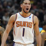 Phoenix Suns guard Devin Booker (1) reacts as he walks off the court in the first half during an NBA basketball game against the Utah Jazz Wednesday, Jan. 26, 2022, in Salt Lake City. (AP Photo/Rick Bowmer)