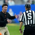 Oklahoma State head coach Mike Gundy argues a call with an official during the first half of the Fiesta Bowl NCAA college football game against Notre Dame, Saturday, Jan. 1, 2022, in Glendale, Ariz. (AP Photo/Ross D. Franklin)