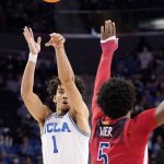 UCLA guard Jules Bernard, left, shoots as Arizona guard Justin Kier defends during the second half of an NCAA college basketball game Tuesday, Jan. 25, 2022, in Los Angeles. (AP Photo/Mark J. Terrill)