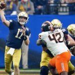 Notre Dame quarterback Jack Coan (17) throws during the first half of the Fiesta Bowl NCAA college football game against Oklahoma State, Saturday, Jan. 1, 2022, in Glendale, Ariz. (AP Photo/Ross D. Franklin)