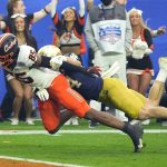 Oklahoma State wide receiver Jaden Bray (85) dives into the end zone for a touchdown as Notre Dame linebacker Jack Kiser defends during the first half of the Fiesta Bowl NCAA college football game, Saturday, Jan. 1, 2022, in Glendale, Ariz. (AP Photo/Rick Scuteri)
