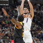 Phoenix Suns guard Devin Booker (1) shoots as Utah Jazz forward Royce O'Neale (23) defends in the second half during an NBA basketball game Wednesday, Jan. 26, 2022, in Salt Lake City. (AP Photo/Rick Bowmer)