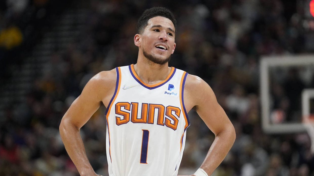 Phoenix Suns guard Devin Booker (1) smiles as he walks off the court in the second half during an N...