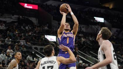 Phoenix Suns guard Devin Booker (1) shoots against the San Antonio Spurs during the second half of ...