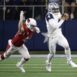 Dallas Cowboys quarterback Dak Prescott (4) is chased by Arizona Cardinals linebacker Dennis Gardeck (45) during the second half of an NFL football game Sunday, Jan. 2, 2022, in Arlington, Texas. (AP Photo/Ron Jenkins)