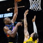 Phoenix Suns center Bismack Biyombo, left, shoots over Indiana Pacers guard Duane Washington Jr. (4) during the second half of an NBA basketball game Saturday, Jan. 22, 2022, in Phoenix. (AP Photo/Ross D. Franklin)