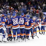 The New York Islanders congratulate goaltender Ilya Sorokin (30) after they won an NHL hockey game against the Arizona Coyotes, Friday, Jan. 21, 2022, in Elmont, N.Y. (AP Photo/Corey Sipkin).