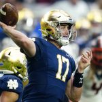 Notre Dame quarterback Jack Coan (17) throws against Oklahoma State during the first half of the Fiesta Bowl NCAA college football game, Saturday, Jan. 1, 2022, in Glendale, Ariz. (AP Photo/Ross D. Franklin)