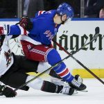 New York Rangers right wing Julien Gauthier (15) skates against Arizona Coyotes defenseman Kyle Capobianco (75) during the third period of an NHL hockey game, Saturday, Jan. 22, 2022, at Madison Square Garden in New York. The Rangers won 7-3. (AP Photo/Mary Altaffer)