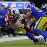 Arizona Cardinals tight end Darrell Daniels (81) is tackled by Los Angeles Rams defensive end A'Shawn Robinson, left, and inside linebacker Troy Reeder during the second half of an NFL wild-card playoff football game in Inglewood, Calif., Monday, Jan. 17, 2022. (AP Photo/Mark J. Terrill)