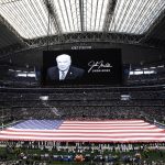 A tribute to John Madden is displayed before an NFL football game between the Arizona Cardinals and h= Sunday, Jan. 2, 2022, in Arlington, Texas. (AP Photo/Roger Steinman)
