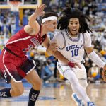 UCLA guard Tyger Campbell, right, drives toward the basket as Arizona guard Kerr Kriisa defends during the second half of an NCAA college basketball game Tuesday, Jan. 25, 2022, in Los Angeles. (AP Photo/Mark J. Terrill)