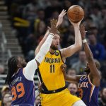 Indiana Pacers' Domantas Sabonis (11) makes a pass against Phoenix Suns' Jae Crowder (99) and Chris Paul (3) during the second half of an NBA basketball game, Friday, Jan. 14, 2022, in Indianapolis. (AP Photo/Darron Cummings)