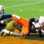 Oklahoma State wide receiver Tay Martin, right, falls into the end zone for a touchdown during the second half of the Fiesta Bowl NCAA college football game as Notre Dame cornerback Clarence Lewis defends, Saturday, Jan. 1, 2022, in Glendale, Ariz. (AP Photo/Ross D. Franklin)