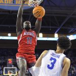 Arizona center Oumar Ballo, left, dunks as UCLA guard Johnny Juzang defends during the second half of an NCAA college basketball game Tuesday, Jan. 25, 2022, in Los Angeles. (AP Photo/Mark J. Terrill)